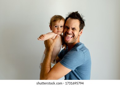 Single Dad Going Nuts At Home With A Baby, Making Faces.