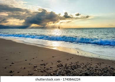 As A Single Dark Cloud Looms Overhead A Sailboat Is Sailing Into Sun Rays Of Light