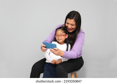 Single Divorced Latina Mom And Daughter Use Cell Phone To Video Call, Take Selfies, Play Video Games, And Shop Online