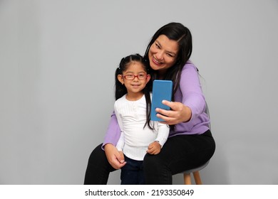 Single Divorced Latina Mom And Daughter Use Cell Phone To Video Call, Take Selfies, Play Video Games, And Shop Online