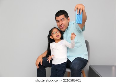 Single Divorced Latino Dad And Daughter Use Cell Phone To Video Call, Take Selfies, Play Video Games, And Shop Online