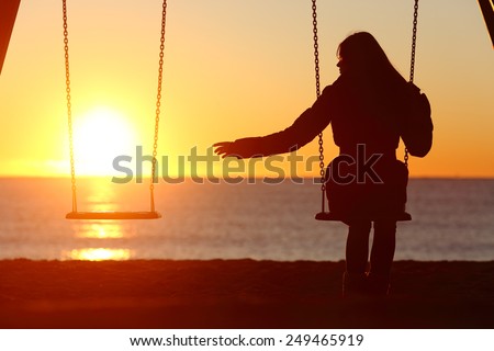 Single or divorced woman alone missing a boyfriend while swinging on the beach at sunset ストックフォト © 