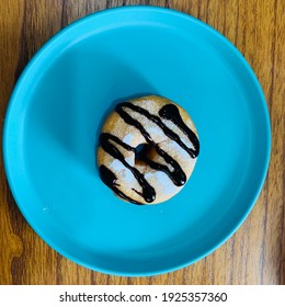 A single donnut with chocolate topping