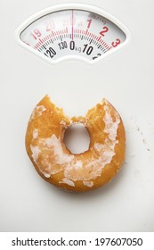 Single Donut Shot On A Scale For Weighing Yourself