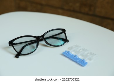 Single Dose Eye Drops And Glasses On White Table