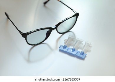 Single Dose Eye Drops And Glasses On White Table