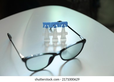 Single Dose Eye Drops And Glasses On White Table