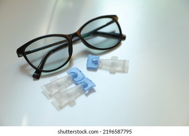 Single Dose Eye Drops And Glasses On White Table