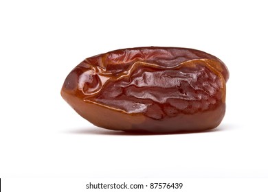 Single dried date fruit from low perspective on white background.