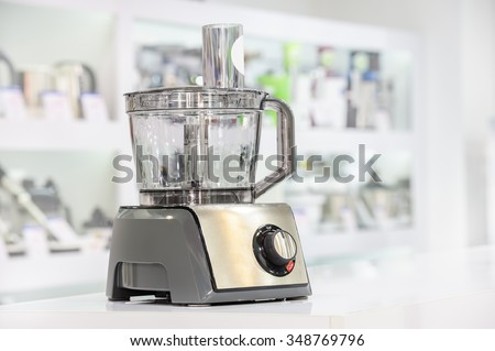 single electric food processor at retail store shelf, defocused background
