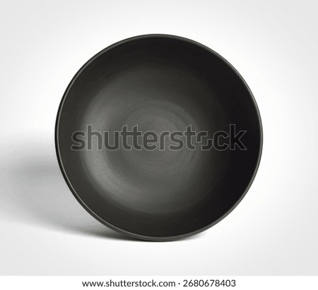 A single, empty, dark grey ceramic bowl is presented from a top-down perspective against a clean white background, casting a subtle shadow.