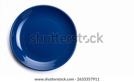A single, empty, round, darkblue plate sits on a plain white background. The plate is glossy and appears to be ceramic. The image is simple and minimalist.