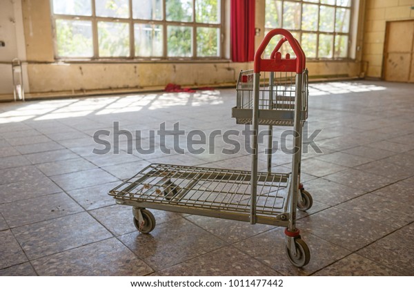 Single\
empty shopping cart in the abandoned\
building