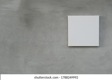 Single Empty White Square Canvas Frame On Grunge Grey Concrete Wall Background