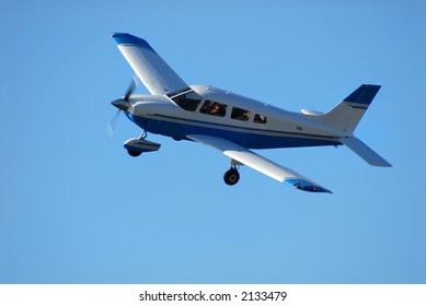 Single Engine Airplane In Flight Against A Clear Blue Sky