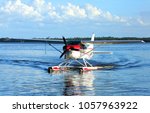 Single engine seaplane turns in the water and prepares to stop at Wooten Park, Tavares, Florida.