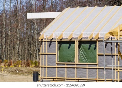 Single Family Home Construction. Interior Frame Of New Wooden House Under Construction. House Under Construction With The Roof Structure Of Wood. Construction Frame House Made Of Wood, With Roof