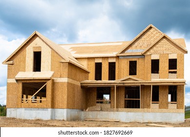 A single family home under construction the house has been framed and covered in plywood industry roof - Shutterstock ID 1827692669