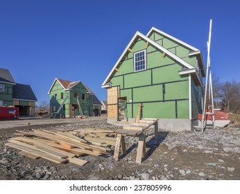 A Single Family Home Under Construction In A Housing Development Complex.