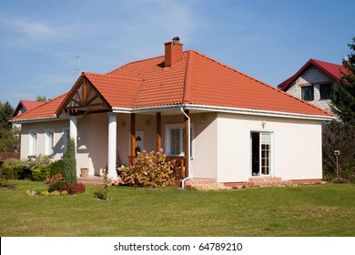 Single Family Small House In Bright Color Against Blue Sky