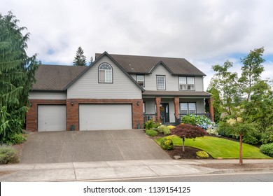 Single Family Three Car Garage Home With Landscaped Frontyard In Suburban North America Neighborhood