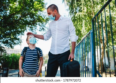 Single Father Going To Work And Taking Son To School During Epidemic. They Are Wearing A Face Mask.