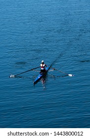 Single Female Rower In Racing Boat 