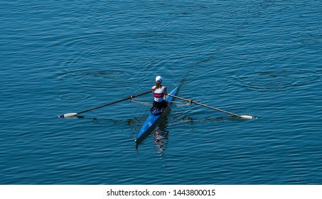 Single Female Rower In Racing Boat 