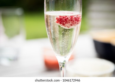 Single Glass Of Prosecco With Raspberry