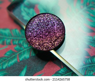 Single Glittery Violet Eye Shadow On Floral Leaf Background With Acrylic