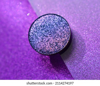 Single Glittery Violet Eye Shadow On Violet And Glittery Background