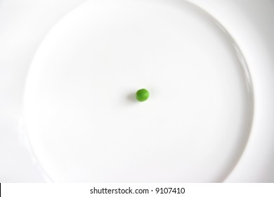 Single Green Pea On White Plate