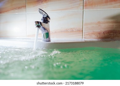 Single Handle Faucet Pouring Hot Water In A Bath Tub