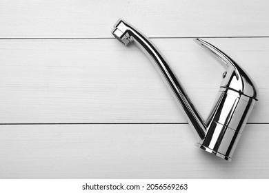 Single Handle Water Tap On White Wooden Table, Top View. Space For Text