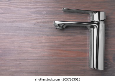 Single Handle Water Tap On Wooden Table, Top View. Space For Text