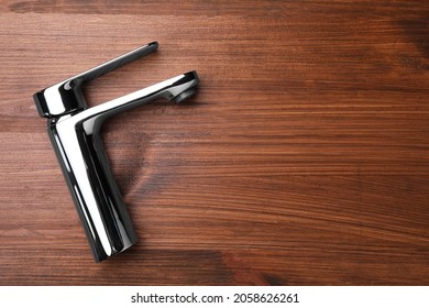 Single Handle Water Tap On Wooden Table, Top View. Space For Text