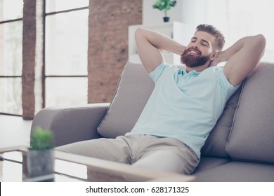 Single Happy Young Man Is Relaxing On The Sofa At Home. He Is Dreaming About Vacation, That Is Coming