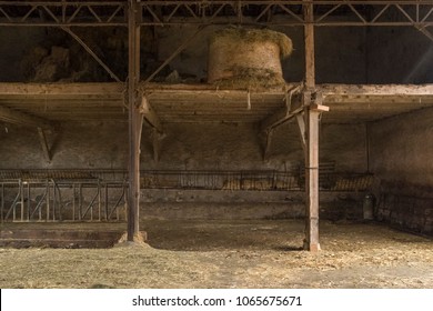 single hay bale on barn top shelf and hay spread on the barn floor