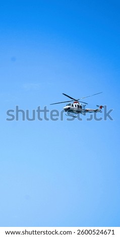 Single helicopter in a blue sky