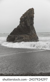 Single high sharp rock standing in the Pacific Ocean at Ruby Beach, Washington