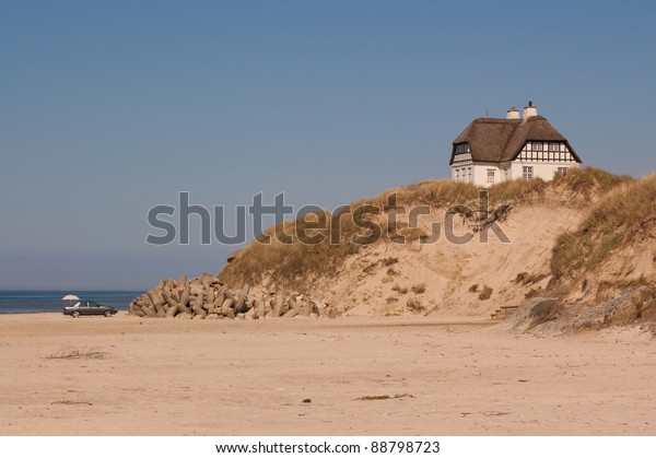 Single house an a hill at\
the beach.