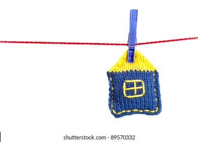 Single Knitted House On A Red String Isolated On White Background