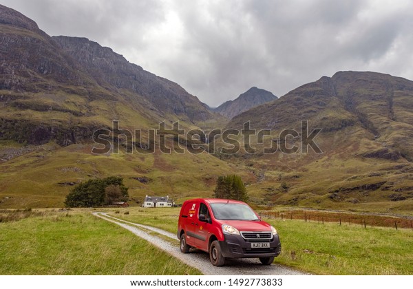 Single lane\
road, Scotland, UK - April 10, 2019: car driving on the narrow one\
lane road in rural Scottish\
Highlands