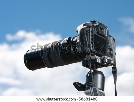 A single lens reflex camera mounted on a tripod.