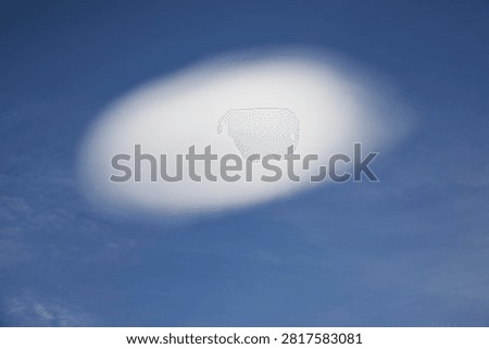 Single lenticularis cloud in front of blue sky