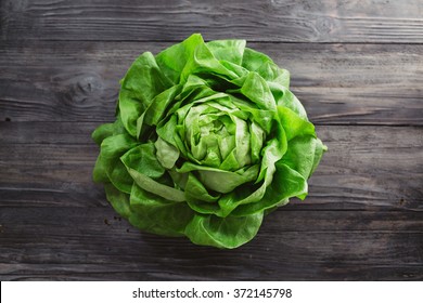 Single Lettuce Head Over Rustic Wooden Background