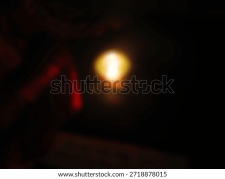 A single light source that is very bright and dim in the center.