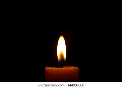 A Single, Lit Candle In The Dark