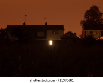 A Single Lit Window Downstairs At The Back Of A House During The Dark Of Night; Essex; England; UK