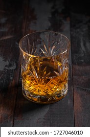 Single Malt Scotch Whiskey In Crystal Glass On Wooden Table Background.